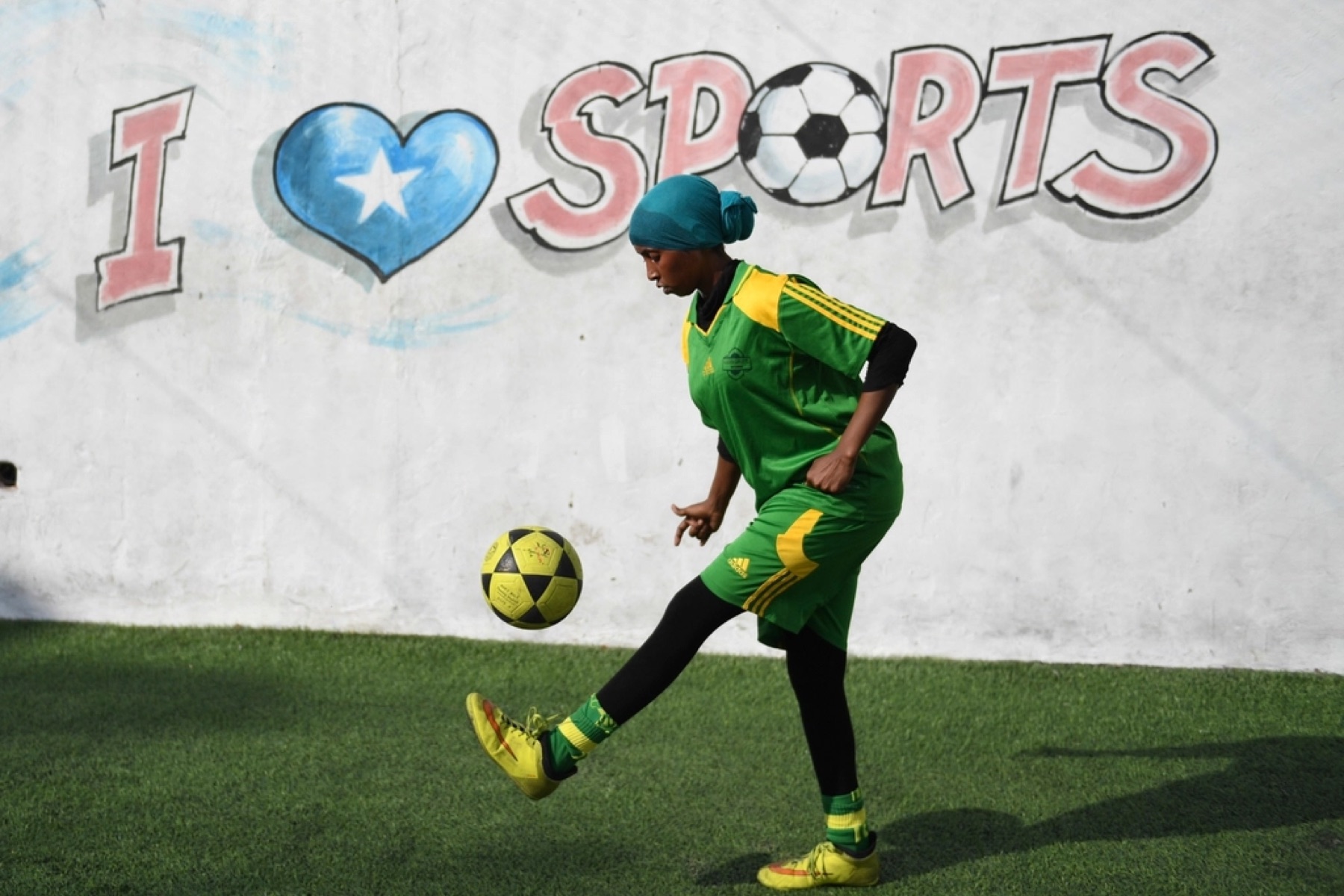 Player dribbling the ball past a defender during a match