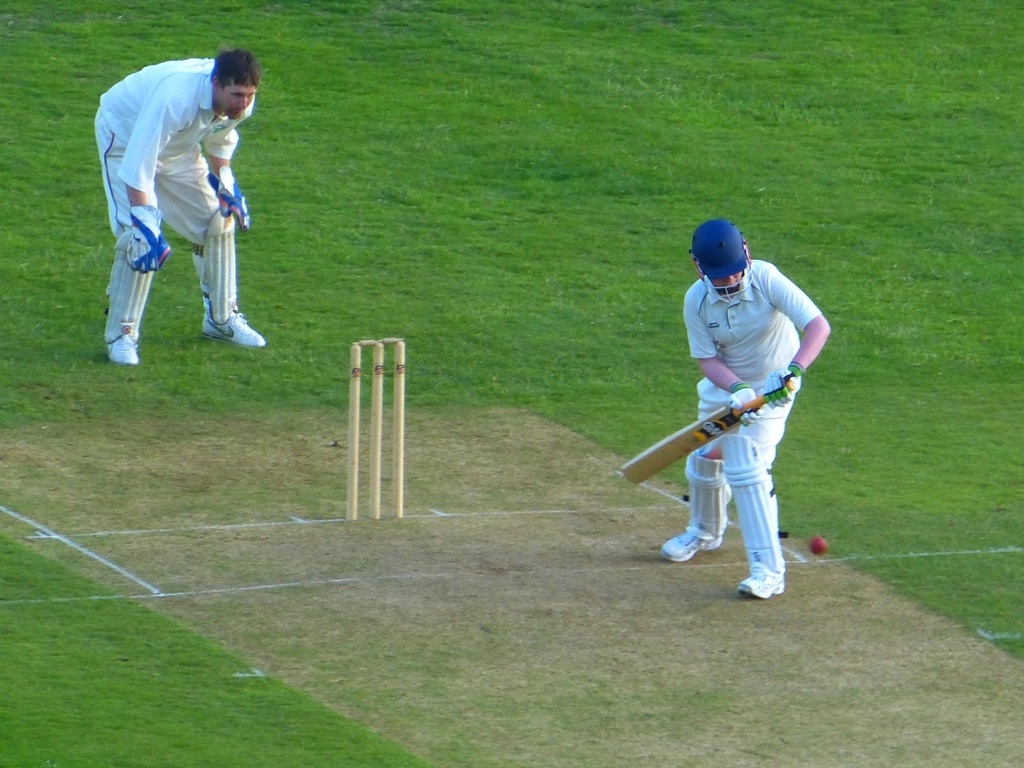 Cricket batsman and wicketkeeper during a match