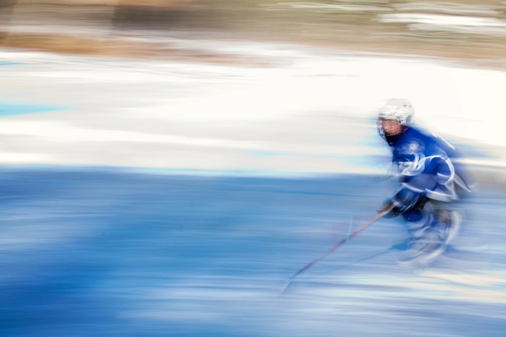 Ice hockey player skating on the rink